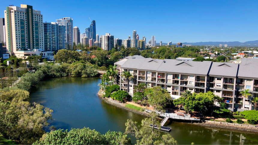 Buildings and trees in the city against clear sky